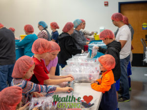 Health-e Giving - Feeding Children Everywhere Kids at Assembly Line